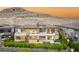 Rear exterior view of home featuring a pool, patio, spiral staircase, and mountain views at 11152 San Terrazo Pl, Las Vegas, NV 89141