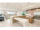 Bright kitchen with an island, stainless steel appliances, custom cabinets, and views of the outside at 11152 San Terrazo Pl, Las Vegas, NV 89141