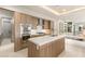 Contemporary kitchen with stainless steel appliances, custom cabinets, and an island with a white countertop at 11152 San Terrazo Pl, Las Vegas, NV 89141
