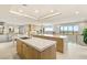 Open-concept kitchen featuring dual islands, custom wood cabinetry, and plenty of natural light at 11152 San Terrazo Pl, Las Vegas, NV 89141