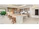 Spacious kitchen featuring a large island with seating, stainless steel appliances, and custom wood cabinetry at 11152 San Terrazo Pl, Las Vegas, NV 89141