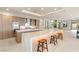 Modern kitchen featuring an island with seating, stainless steel appliances, and light wood cabinetry at 11152 San Terrazo Pl, Las Vegas, NV 89141