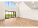Bright and airy living area with high ceilings, hardwood floors, and views of the lush outdoor scenery at 11152 San Terrazo Pl, Las Vegas, NV 89141
