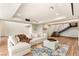 Spacious living room with hardwood floors and a comfortable white sofa and staircase at 11152 San Terrazo Pl, Las Vegas, NV 89141