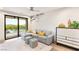 Cozy living room with a neutral color palette, plush seating, and access to an outdoor balcony at 11152 San Terrazo Pl, Las Vegas, NV 89141