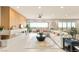 Spacious living room with a modern linear fireplace, ceiling fan, and comfortable sectional sofa for relaxing at 11152 San Terrazo Pl, Las Vegas, NV 89141