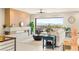 Bright living room featuring a linear fireplace, ceiling fan, and large sliding glass doors showcasing city views at 11152 San Terrazo Pl, Las Vegas, NV 89141