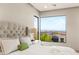 A well-lit main bedroom with a modern headboard and a large window offering a scenic view at 11152 San Terrazo Pl, Las Vegas, NV 89141