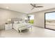 A bright main bedroom with modern furnishings, light floors and access to a private balcony at 11152 San Terrazo Pl, Las Vegas, NV 89141