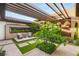 Serene patio area with comfortable seating, modern pergola, and lush landscaping at 11152 San Terrazo Pl, Las Vegas, NV 89141