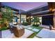 Stylish outdoor patio with cozy seating, modern pergola, and lush landscaping perfect for entertaining at 11152 San Terrazo Pl, Las Vegas, NV 89141