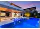 Stunning pool view at dusk, complemented by outdoor lounge area and ambient lighting at 11152 San Terrazo Pl, Las Vegas, NV 89141