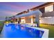Luxurious infinity pool with chaise lounges, outdoor living space, and scenic views, perfect for relaxation at 11152 San Terrazo Pl, Las Vegas, NV 89141