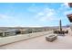 Spacious rooftop deck with ample seating, fire pit, and panoramic views of the surrounding cityscape and mountains at 11152 San Terrazo Pl, Las Vegas, NV 89141