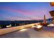 Experience luxury on this rooftop deck, featuring a cozy fire pit and stunning sunset views over the city skyline at 11152 San Terrazo Pl, Las Vegas, NV 89141