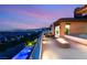 Luxurious rooftop deck with a pool and fire pit, offering stunning city views at dusk for ultimate relaxation and entertainment at 11152 San Terrazo Pl, Las Vegas, NV 89141