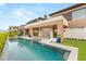 Luxury backyard with a modern pool, lounge chairs, and sleek architectural design at 11152 San Terrazo Pl, Las Vegas, NV 89141