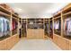 Spacious walk-in closet featuring custom wood shelving and ample storage space for clothes and accessories at 11152 San Terrazo Pl, Las Vegas, NV 89141
