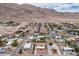 A neighborhood in a desert area, with single Gathering homes and desert landscaping with mountain views at 138 Palma Del Rio, Las Vegas, NV 89110