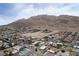 A desert neighborhood, with single Gathering homes with mature trees and desert landscaping with mountain views at 138 Palma Del Rio, Las Vegas, NV 89110