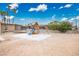 Backyard featuring playground equipment, a trampoline, and desert landscaping at 138 Palma Del Rio, Las Vegas, NV 89110