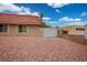 Desert home featuring desert landscaping and a white gate at 138 Palma Del Rio, Las Vegas, NV 89110