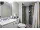 Bathroom featuring tiled floors, a modern vanity with a mirror and tiled walk-in shower at 138 Palma Del Rio, Las Vegas, NV 89110