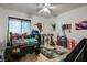 Fun bedroom with ceiling fan, custom bed, dinosaur accents, and playful decor at 138 Palma Del Rio, Las Vegas, NV 89110