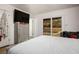 Bedroom boasts backyard views, a modern dresser, a sleek ceiling fan and neutral decor at 138 Palma Del Rio, Las Vegas, NV 89110