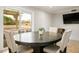 Neutral toned dining room featuring sliding glass doors to the backyard and space for entertaining at 138 Palma Del Rio, Las Vegas, NV 89110