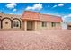 Desert home featuring arched windows, desert landscaping, and a red tiled roof at 138 Palma Del Rio, Las Vegas, NV 89110