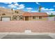 Charming single-story home with a red tile roof, desert landscaping, and mountain views at 138 Palma Del Rio, Las Vegas, NV 89110