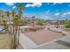 Aerial view of single-story house with well-kept desert landscaping in front and palm trees at 138 Palma Del Rio, Las Vegas, NV 89110