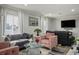 The living room features a sofa, arm chairs, large windows, and a TV on the wall at 138 Palma Del Rio, Las Vegas, NV 89110