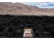 Wide aerial view of neighborhood and mountain backdrop. Desert vegetation throughout at 138 Palma Del Rio, Las Vegas, NV 89110