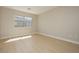 Well-lit bedroom with a large window and hardwood flooring at 1617 Cave Spring Dr, Henderson, NV 89014