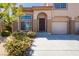 Inviting townhome showcasing desert landscaping, a private garage, and a welcoming front door at 1617 Cave Spring Dr, Henderson, NV 89014