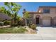 Charming townhome featuring desert landscaping, a private garage, and a welcoming entrance at 1617 Cave Spring Dr, Henderson, NV 89014