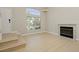 Bright living room featuring a fireplace, a large window, and light wood flooring at 1617 Cave Spring Dr, Henderson, NV 89014