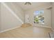 Inviting living room features a staircase, large windows, and light wood flooring at 1617 Cave Spring Dr, Henderson, NV 89014