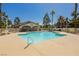 Sparkling community pool surrounded by a concrete deck and well maintained landscaping at 1617 Cave Spring Dr, Henderson, NV 89014