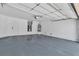 Spacious garage with epoxy flooring, overhead storage, and water heater at 1705 Imperial Cup Dr, Las Vegas, NV 89117