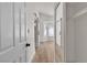Hallway features hardwood floors, white walls, and doors leading to various rooms at 1705 Imperial Cup Dr, Las Vegas, NV 89117