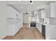 Modern kitchen featuring white cabinets, stainless steel appliances, and wood-look flooring at 1705 Imperial Cup Dr, Las Vegas, NV 89117