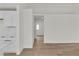 Open concept living room area with hardwood floors and view of the kitchen at 1705 Imperial Cup Dr, Las Vegas, NV 89117
