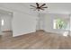 Open living room with wood-look floors, ceiling fan, and lots of natural light at 1705 Imperial Cup Dr, Las Vegas, NV 89117