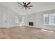Bright living room with fireplace, wood-look floors, and large windows at 1705 Imperial Cup Dr, Las Vegas, NV 89117