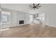 Spacious living room featuring a fireplace, wood-look floors, and lots of natural light at 1705 Imperial Cup Dr, Las Vegas, NV 89117