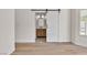 Bright bedroom features wood-look floors and access to the ensuite bathroom at 1705 Imperial Cup Dr, Las Vegas, NV 89117