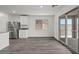 Bright kitchen area boasting stainless steel appliances, gray counters, and sliding doors to the backyard at 1720 Sandia Rock Ave, North Las Vegas, NV 89032